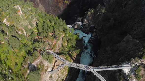 Overhead view of tourists crossing new bridge at Voringsfossen falls, Norway