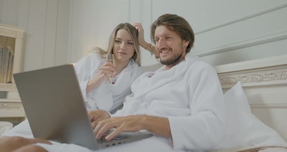 Excited and Happy Man and Woman Looking at Screen of Laptop, Emotion During Playing Games or Trade