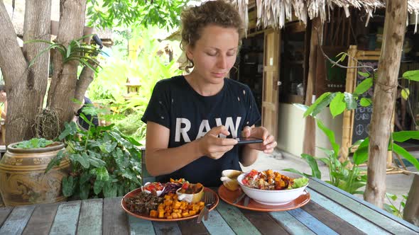 Young Female Travel Food Blogger Photographing Her Lunch With Smartphone In Restaurant