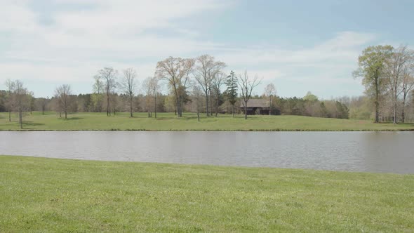 Panning shot of cottage in the background.