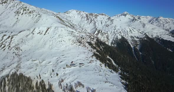 Aerial drone view of snow covered mountains in the winter.