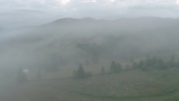 Flight in the Morning Fog Over a Mountain Village