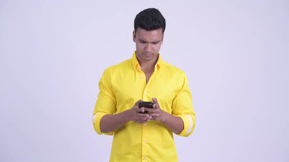 Happy Young Indian Businessman Using Phone