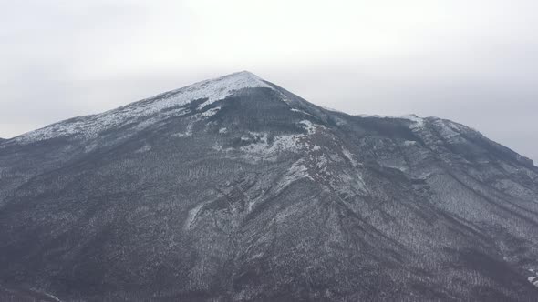 Scenery by winter with pyramid shaped Rtanj mountain 4K drone video