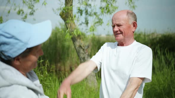 Portrait of an Old Cheerful Man Performing Physical Exercises Taking Care of His Health Together