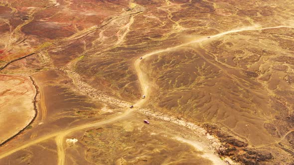 Aerial view of off roads buggy on scenic rock formation trail, Spain.