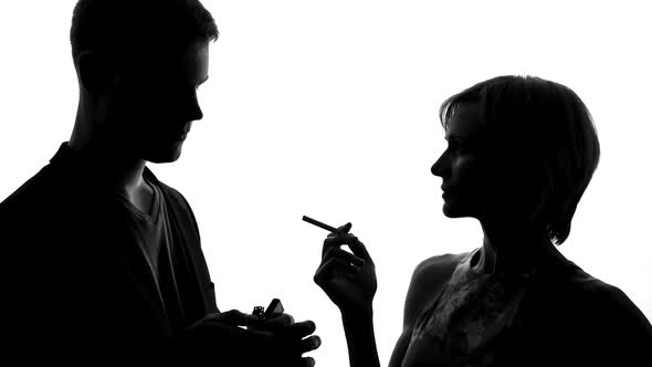 Young Man Coming and Lighting Woman Cigarette, Flirting at Party, Acquaintance