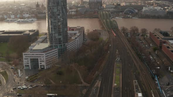 AERIAL: Train Crossing Cologne Hohenzollern Bridge on Sunny Day with Haze in the Sky 