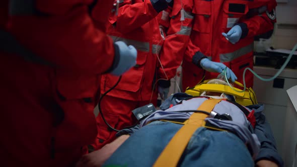 Unrecognizable Ambulance Doctors Saving Life of Victim in Emergency Vehicle