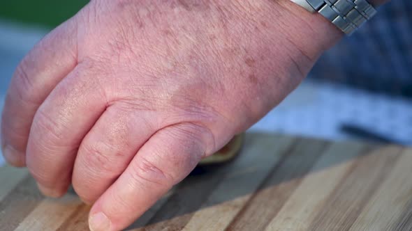 Man Cutting Slices of Deliciuos Figs Outdoor