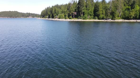 Picturesque Canoe Bay Beach situated on the Sunshine Coast of British Columbia, Canada. Low flying a