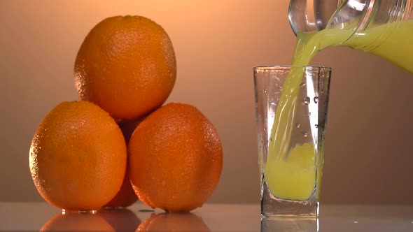 Super Slow Motion Shot of Orange Slice Splashing to Orange Juice