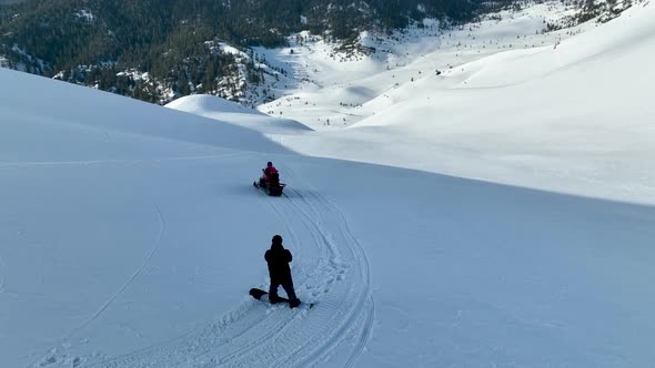 A snowboarder descends from the mountains aerial view 4 K