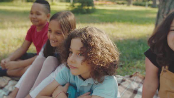 Multiethnic Diverse Children Laughing Sitting on Plaid Outdoors