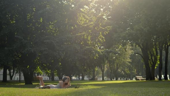 Woman in park watching online TV