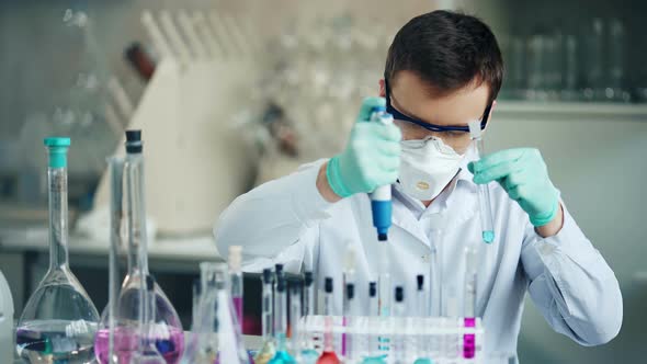 Researcher with Tube and Dropper in the Modern Lab