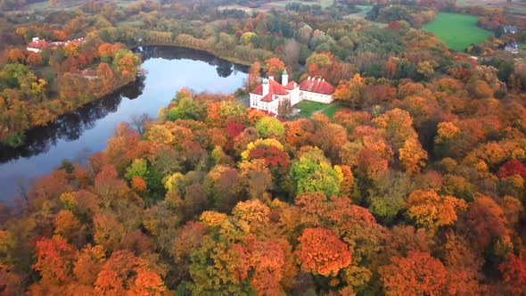 AERIAL Flying over the beautiful autumn Forest and Castle. Flight over beautiful castle; located in