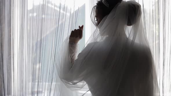 Beautiful and Lovely Bride in Night Gown and Veil. Wedding Morning Preparation