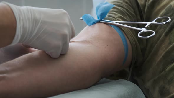 Close Up Footage Nurse Insert Needle Into Man Vein in Order for the Person To Donate Blood. Blood