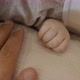 Father Touching and Holding Hands with His Newborn Baby Daughter - VideoHive Item for Sale