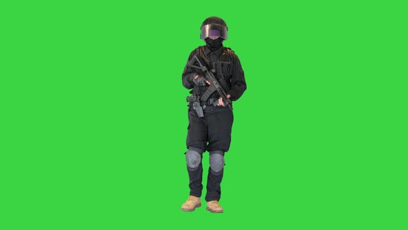 Swat Operator with Assault Rifle Walking on a Green Screen Chroma Key
