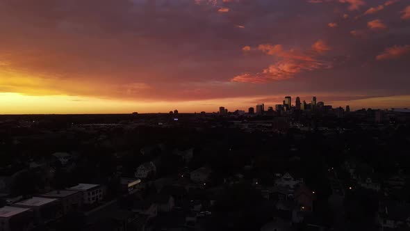 colorful sunset over minneapolis, downtown at the distance, summer time sunset