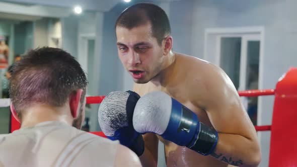 Box Training in the Gym - Two Men Having a Fight on the Ring