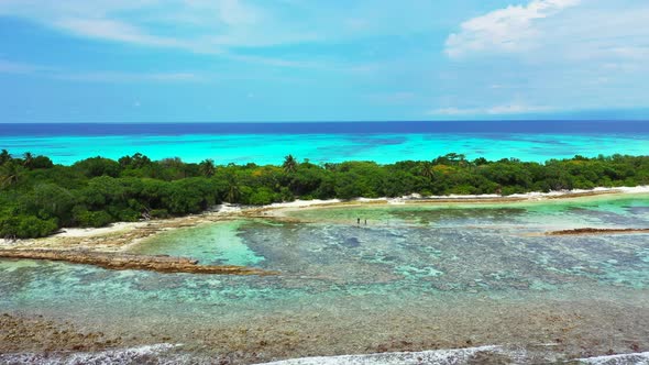 Daytime drone abstract shot of a white paradise beach and blue water background in 4K