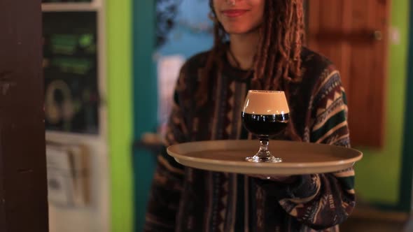 Happy Female Serving Beer in Tray and Glass