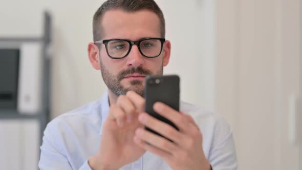 Portrait of Middle Aged Man Using Smartphone