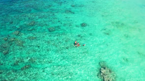 Aerial above scenery of idyllic bay beach holiday by blue water and bright sandy background of a day