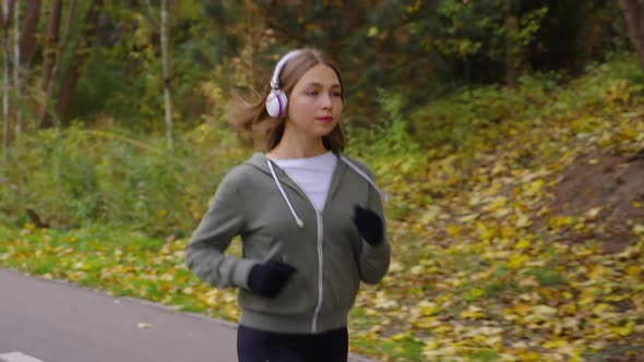 Woman Listening to Audio Book While Jogging