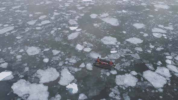 People in Rubber Inflatable Motor Boat Sail in Antarctic Ice.