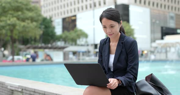 Businesswoman work on notebook computer in city of Hong Kong