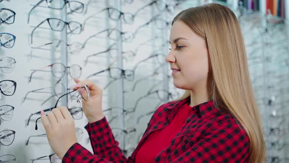 Side view of a pretty blonde in the optical shop. 