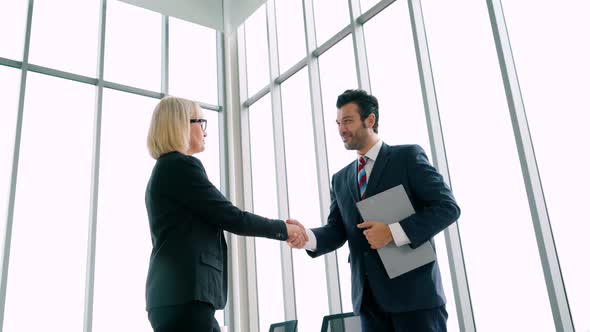 Business People Handshake with Friend at Office
