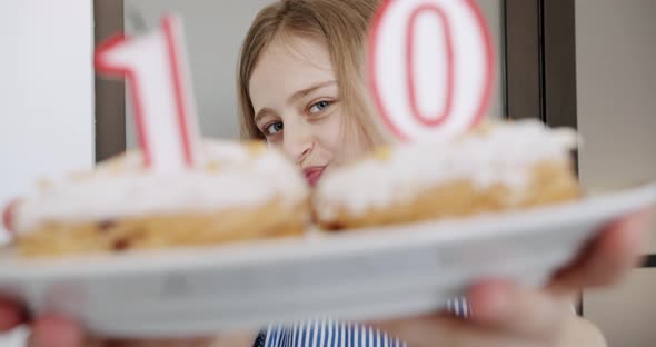 A Birthday Party for a Happy Cute 10 Year Old Girl with Candles on a Cake