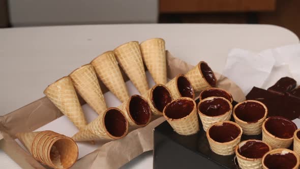 Wafer Cones Smeared With Liquid Chocolate. Dry On Racks.