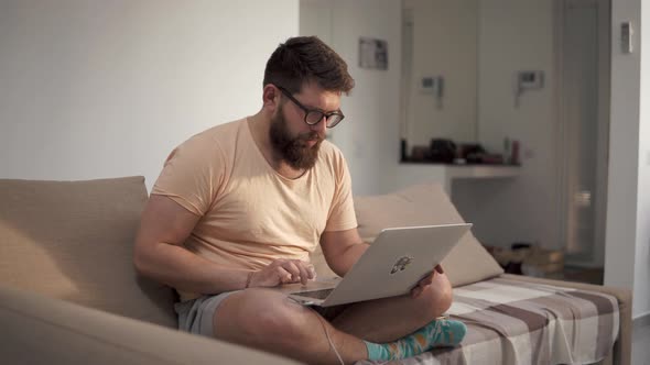 Freelancer Works at Home on a Laptop.