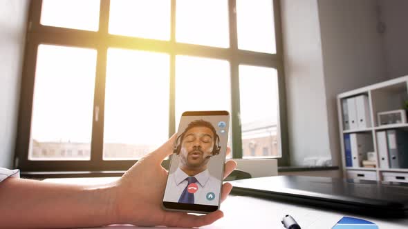 Hand Holding Smartphone with Video Call at Office