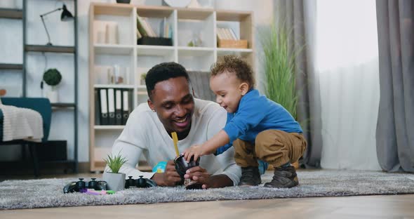 African American Having Fun Together with His Cute Baby Boy when they Together Playing