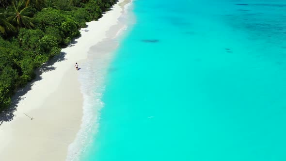 Lady tans on exotic shore beach wildlife by aqua blue ocean and white sand background of the Maldive