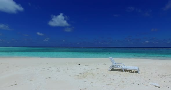 Daytime drone travel shot of a sunshine white sandy paradise beach and blue sea background in hi res