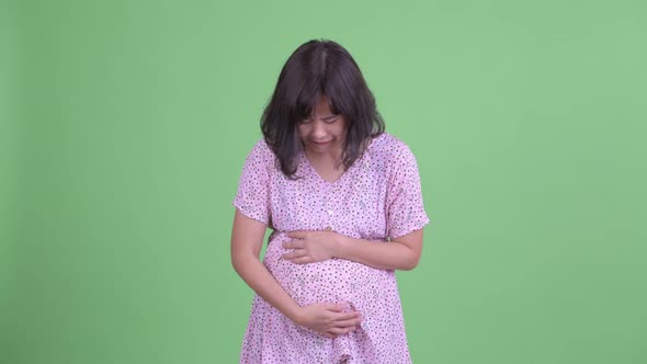 Stressed Asian Pregnant Woman Looking Sad and Crying