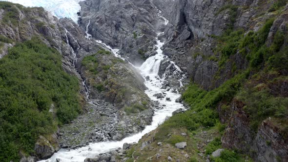 Scenery Of Waterfall Cascades Through Steep Rocky Slope Mountain At National Forest Park In Alaska,
