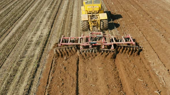 Tractor with Disc Harrows on the Farmland