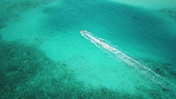 Aerial View of Jet Ski Racing on a Crystal Clear Turquoise Water in Maldives