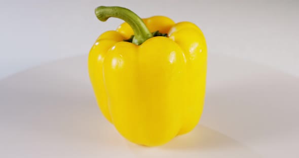 close up a yellow bell pepper rotating on a white background