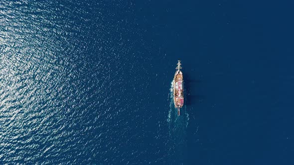 Aerial Top Down Cruise Ship Sailing on Open Sea with Clear Blue Water