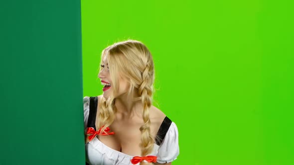 Girl in Bavarian Costume Shows Thumb From the Board, Oktoberfest, Green Screen